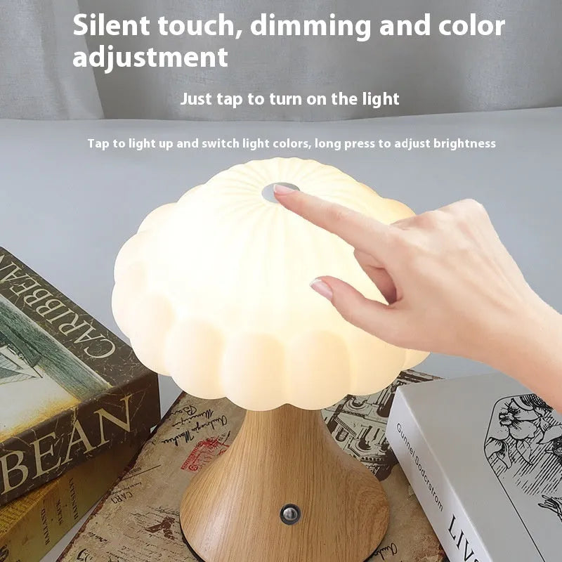 Wood grain coloured mushroom-shaped touch control night light on a wooden surface.