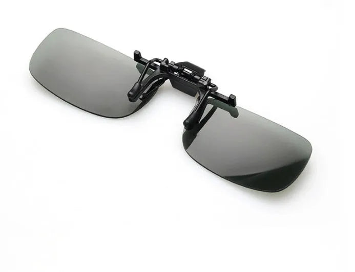 Clip-on night vision polarised sunglasses attached over a pair of prescription glasses for driving.