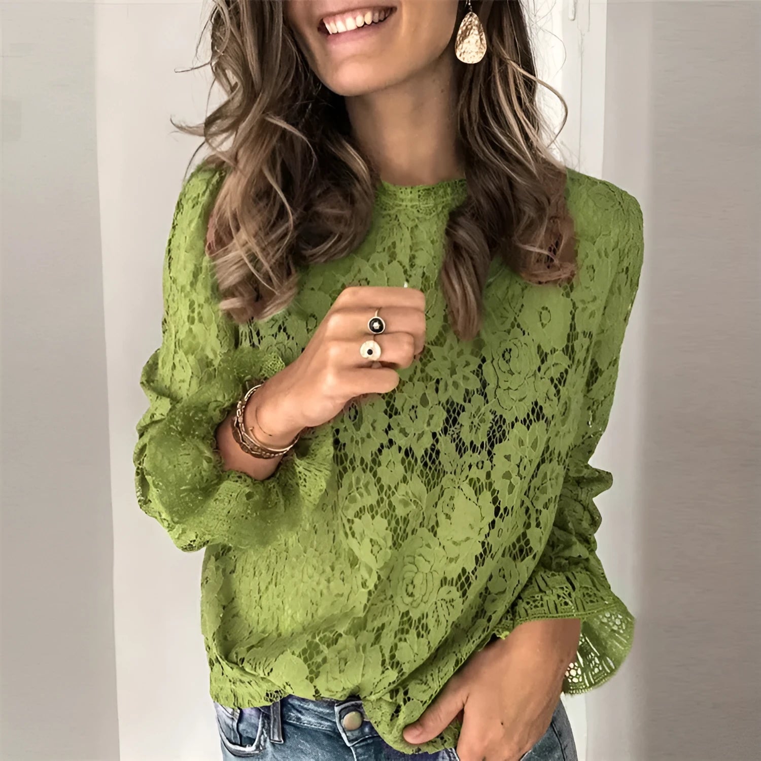 Women's loose-fit hollow lace shirt with long sleeves, round neck, and street-style detailing.