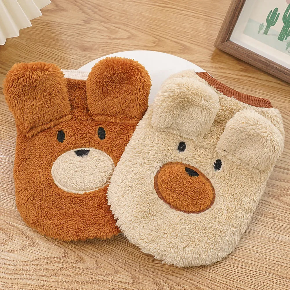 Fleece-lined warm polyester dog coat in cream with bear ears, lying flat showing size tag