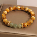 Natural yellow Tiger's Eye stone bracelet in U-shape with auspicious patterns, shown in golden gourd, bamboo joint, and lace styles.