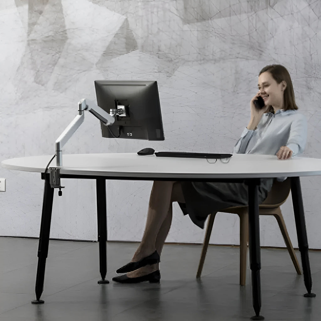 Black aluminium laptop stand with adjustable air pressure arm holding a notebook computer