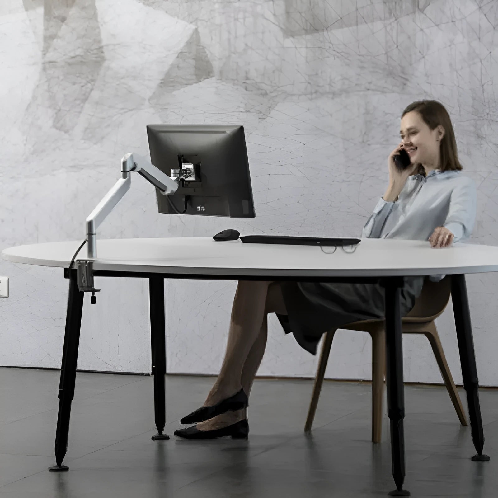 Black aluminium laptop stand with adjustable air pressure arm holding a notebook computer