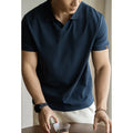 Men's short-sleeve cotton polyester polo shirt in blue, black and white colours showing regular fit design