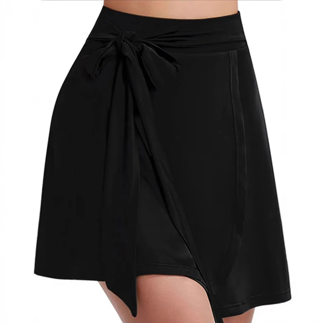 Black thigh-length sports skirt with built-in safety shorts and shoulder straps