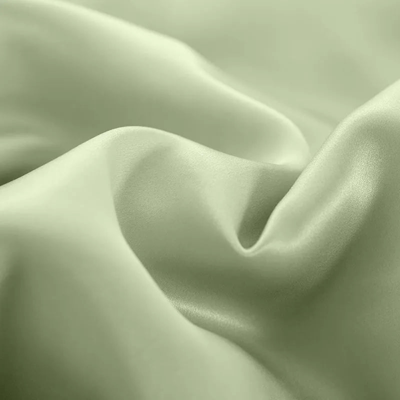 Solid colour silk duvet cover shown in Lotus Pink, double-sided design on a bed
