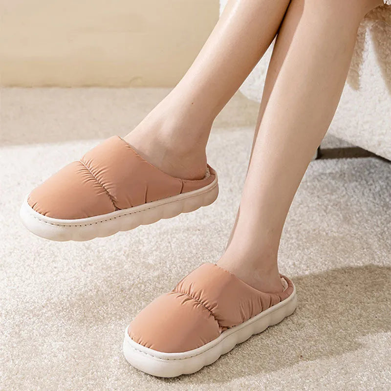 Blue winter slippers for indoor use with a thick rubber non-slip sole and artificial plush lining.