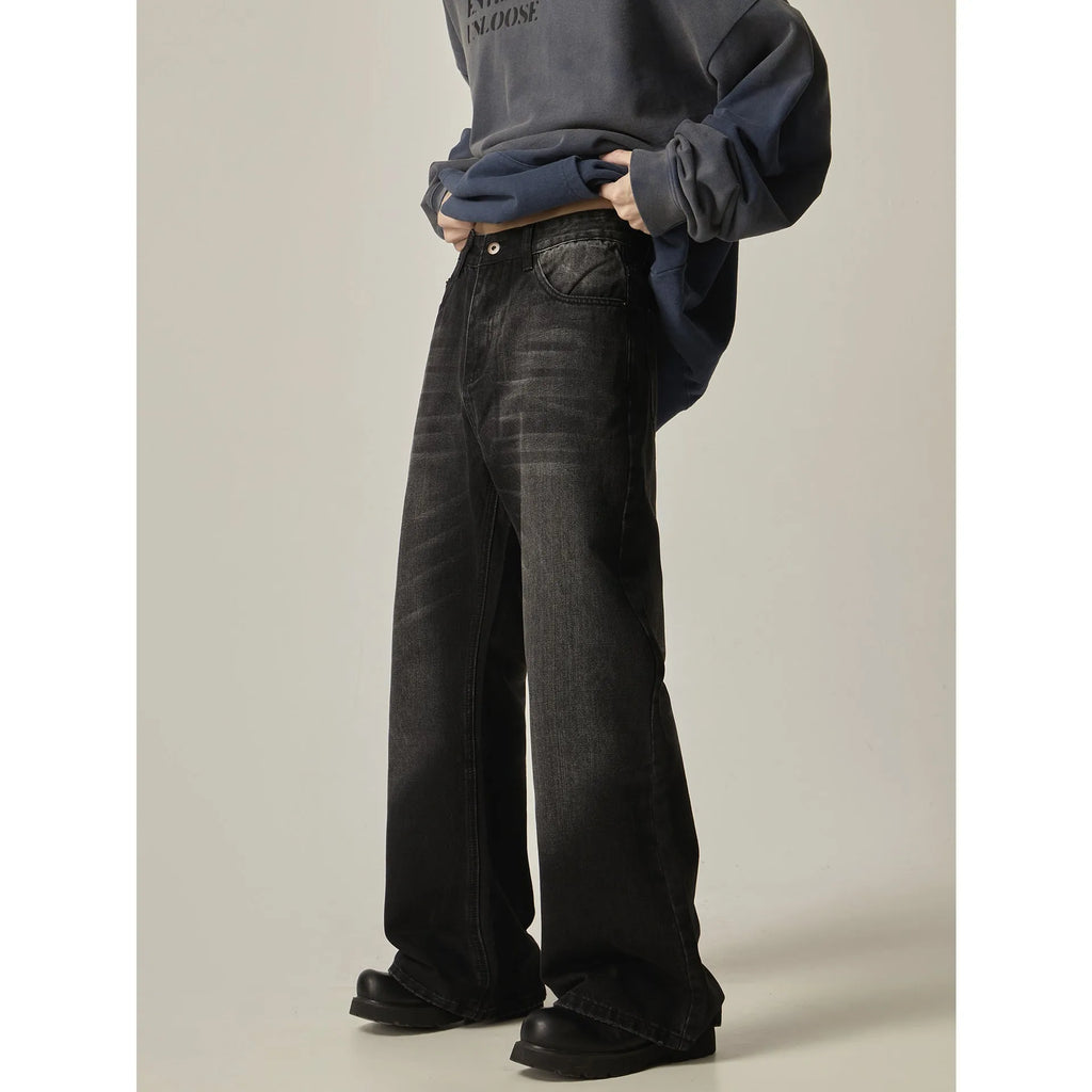 Black loose fit straight leg retro jeans on a hanger, showing zipper fly and relaxed silhouette.