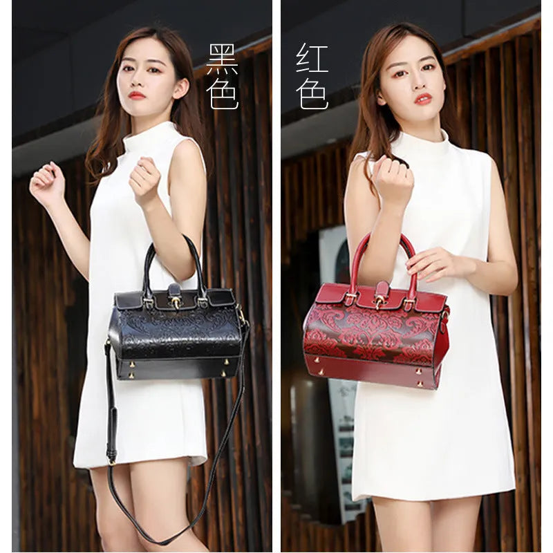 Red vintage women's crossbody leather bag with embossed pattern and multiple internal compartments