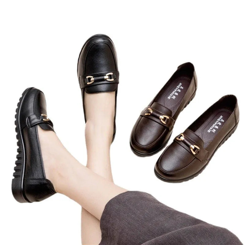 Black women's casual slip-on pumps with a round toe, low heel, and metallic detail.