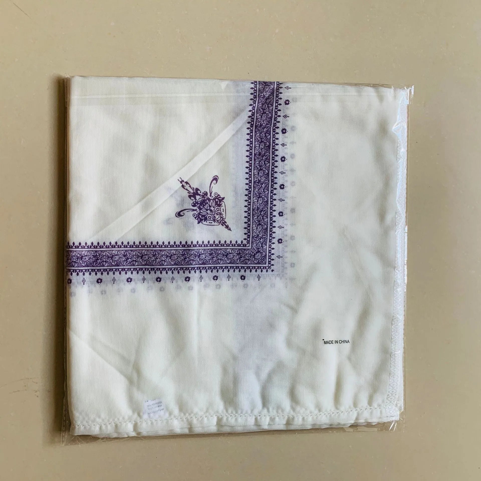 Printed polyester square scarf in brown, gray, green, purple, magenta, or navy blue, measuring 138 x 138 cm.