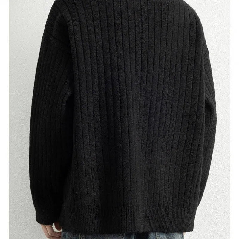 Man wearing a grey half-zip textured knit pullover sweater with a loose fit.