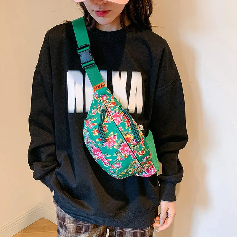 Women's Western-style floral waist bag in nylon with adjustable strap showing contrast stitching
