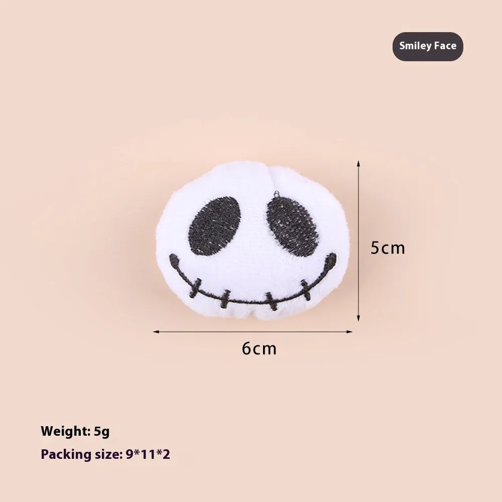 Small plush cat teaser wand toy showing candy, skull and eye patterns on soft fabric