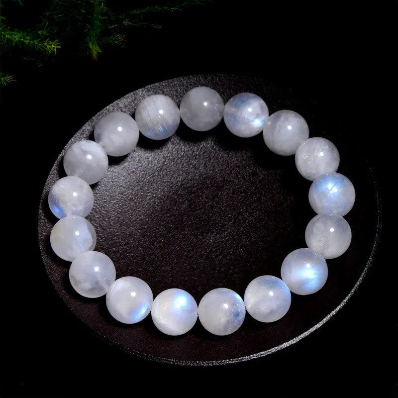 Natural blue moonlight round bead moonstone bracelet showing polished geometric beads on wrist