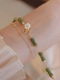 Handmade natural olivine women's bracelet with Chinese double layer twin bells and an olive branch design.