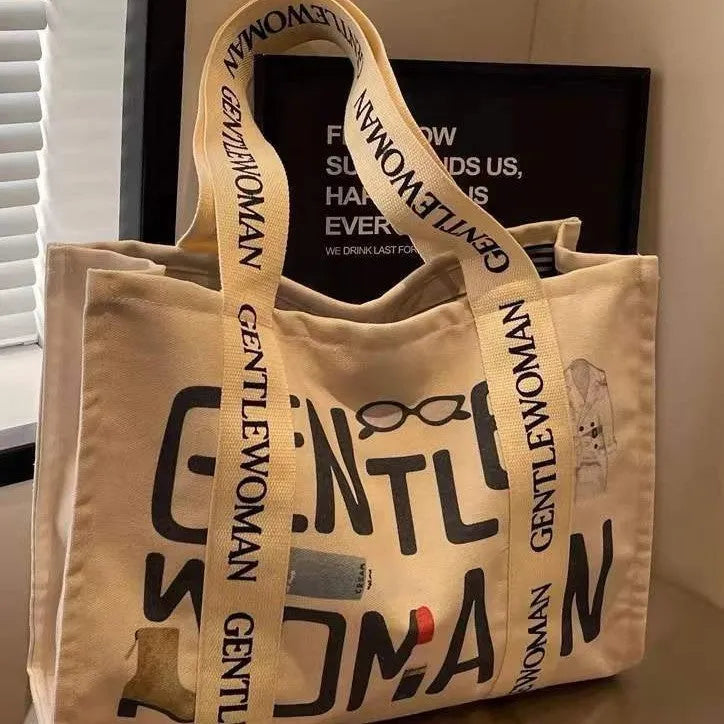 Canvas tote bag with printed design options including black letters, coloured letters, and pattern styles