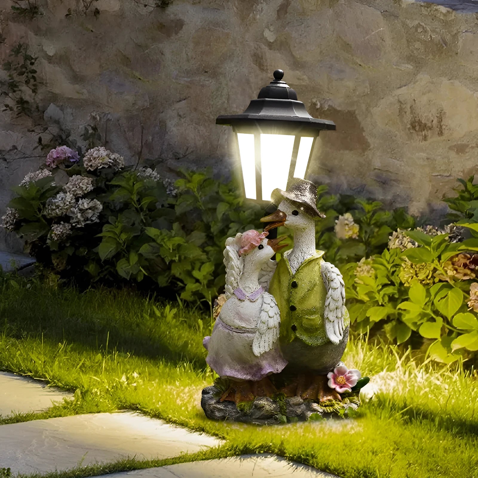 Solar hexagonal garden lamp with resin sculpture decoration in garden setting