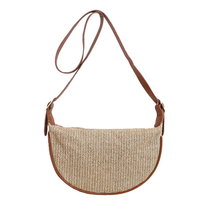Women's straw woven crossbody bag showing texture and internal phone and file compartments.