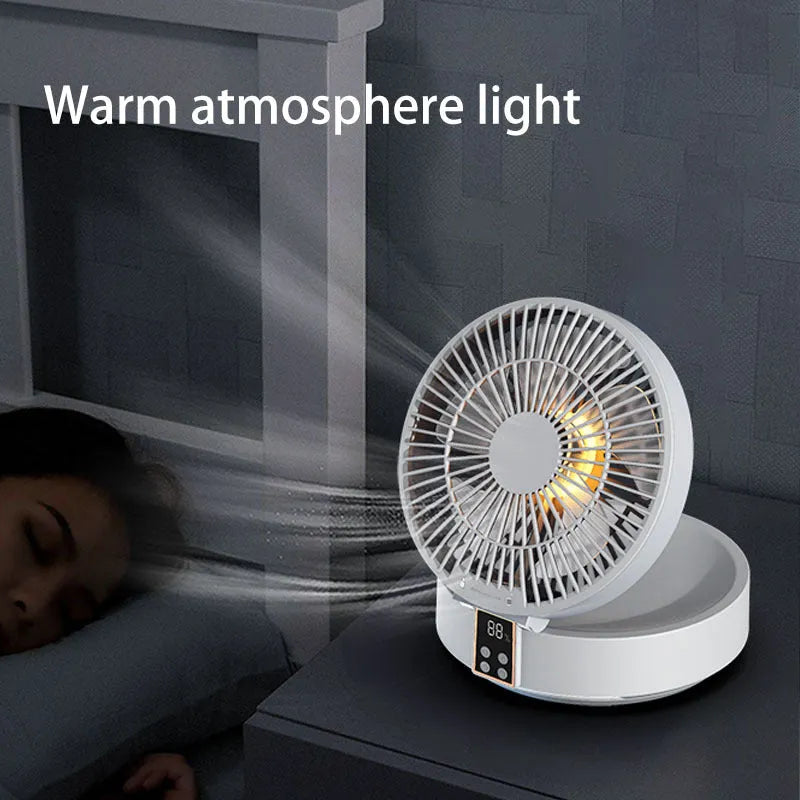 White rechargeable folding USB ceiling fan with remote control on wooden desk