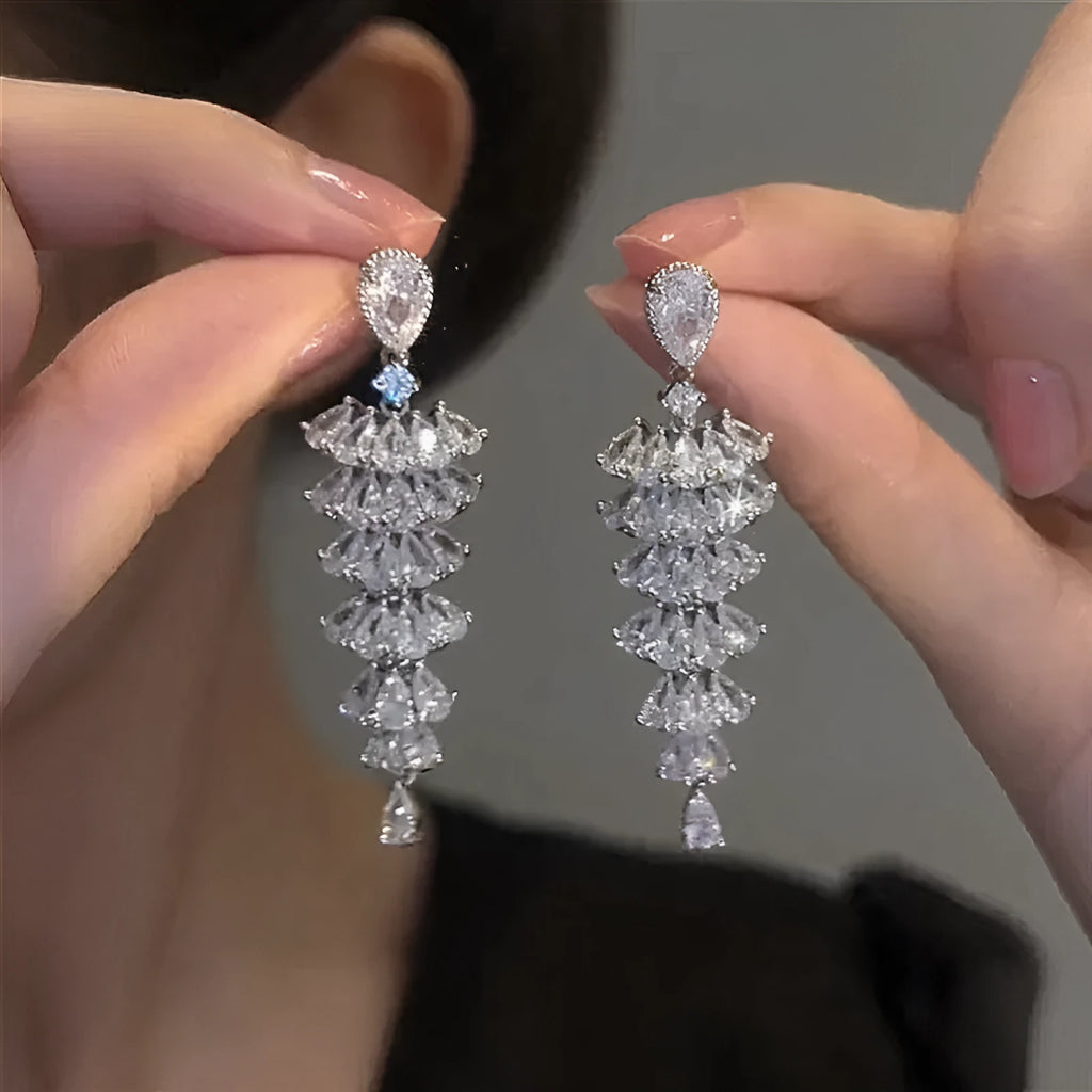 Women's silver pagoda Christmas tree drop earrings with a dangling zircon star on copper studs.