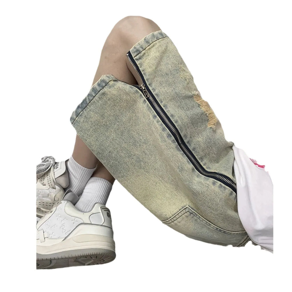 Men's blue denim shorts with a yellow mud distressed finish, rips, loose five-point fit, and button cardigan closure.