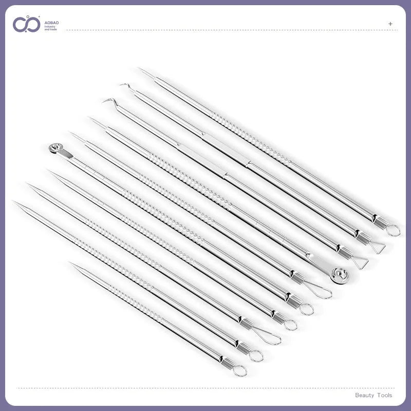 Four silver metal acne needles with pointed tips laid out on a surface.