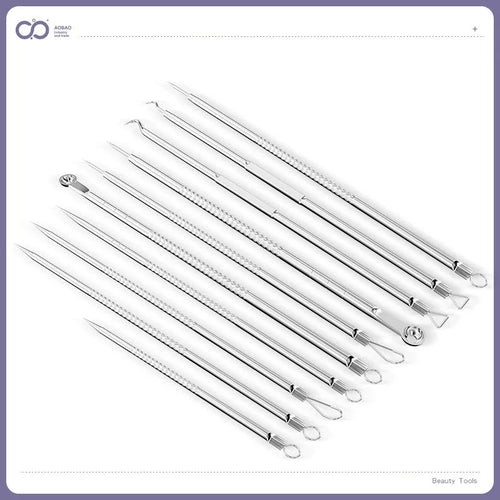 Four silver metal acne needles with pointed tips laid out on a surface.