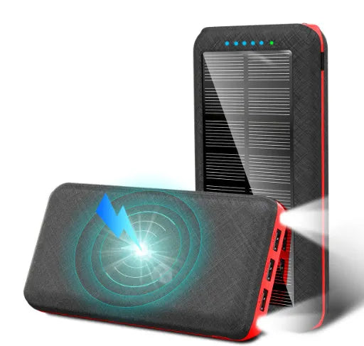 Black portable power bank with Qi wireless charging pad, three USB ports, and an LED flashlight on the front.