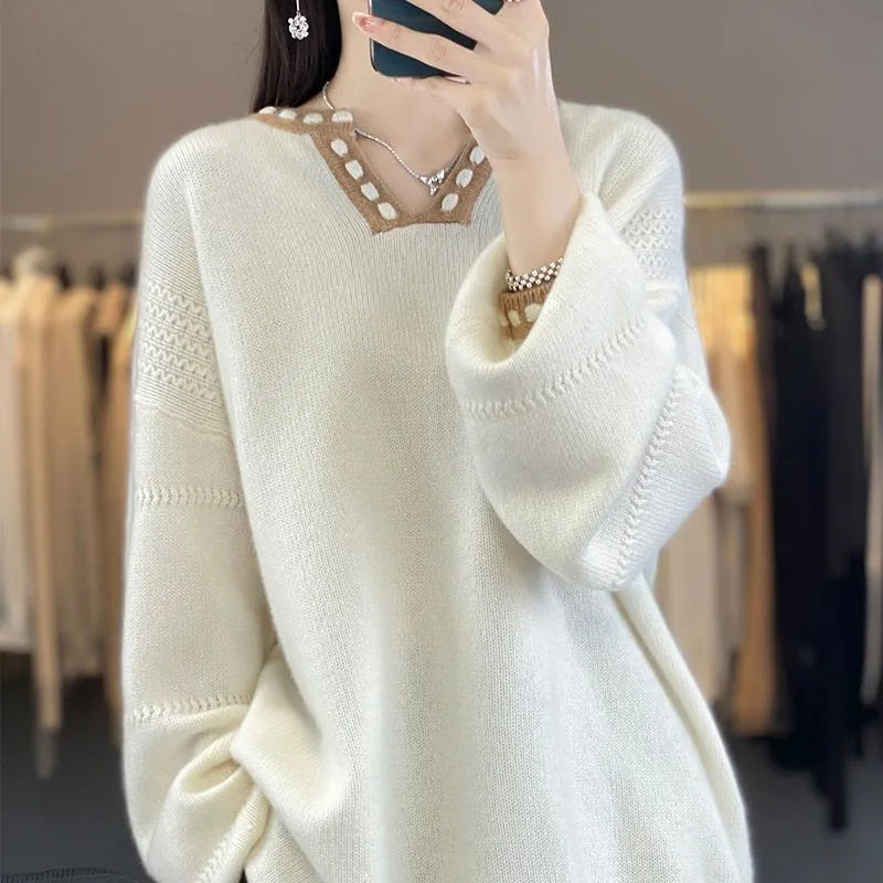 Women's camel coloured V-neck long sleeve viscose sweater laid flat.
