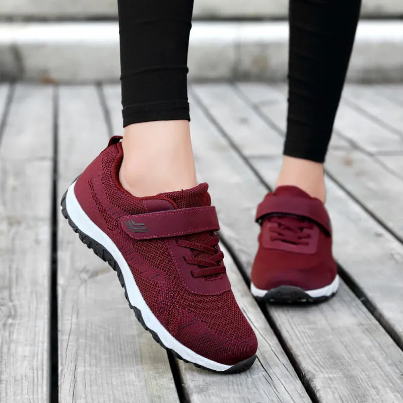 Women's grey purple breathable mesh shoes with a velcro strap and wedge heel on a composite sole.