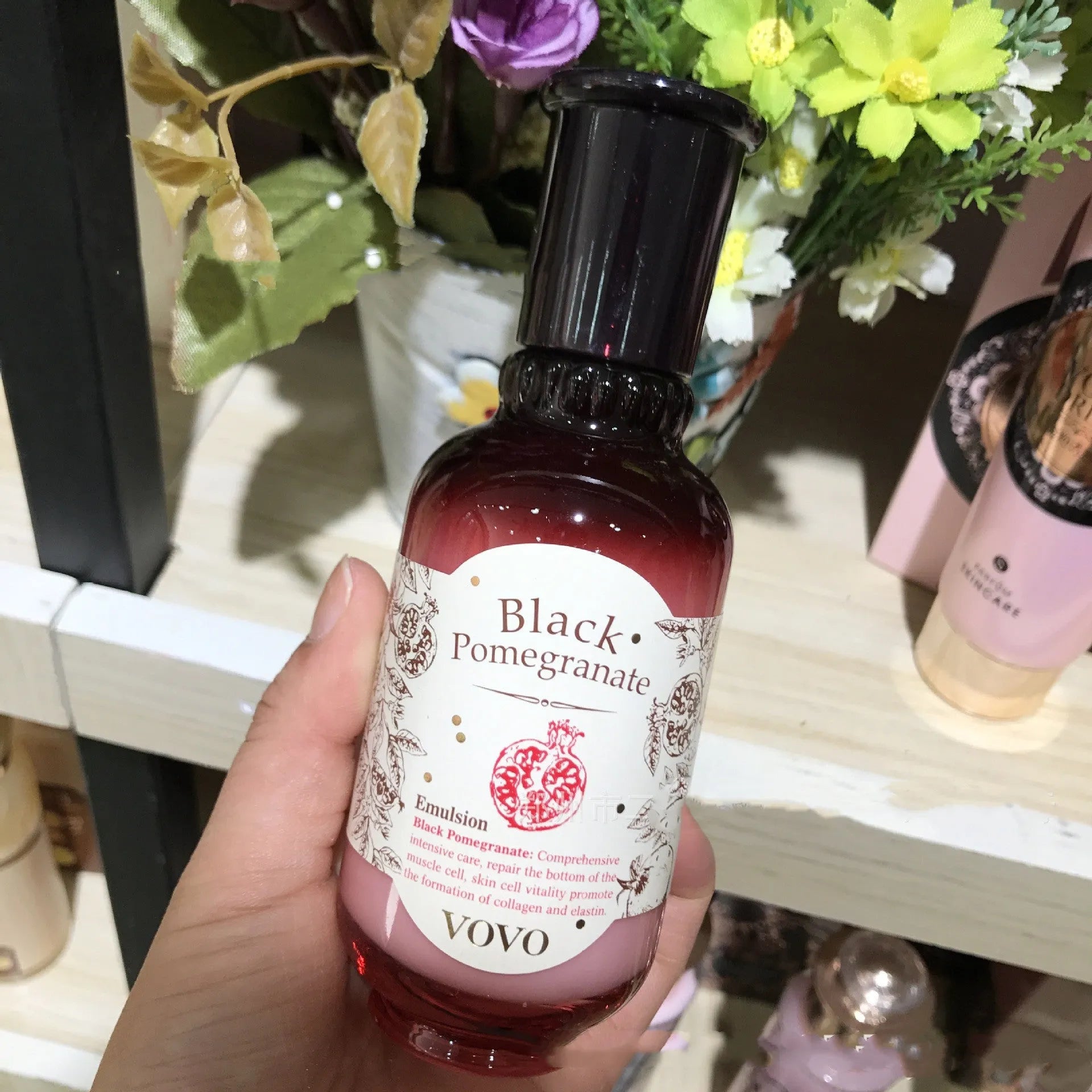 Pomegranate skincare set showing six bottles: cleanser, water, milk, essence, cream, and eye cream.