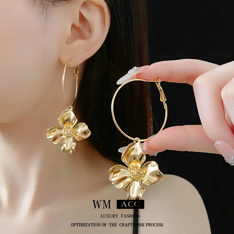 Flower and geometric design metal earrings in gold or silver electroplated finish with silver needle posts
