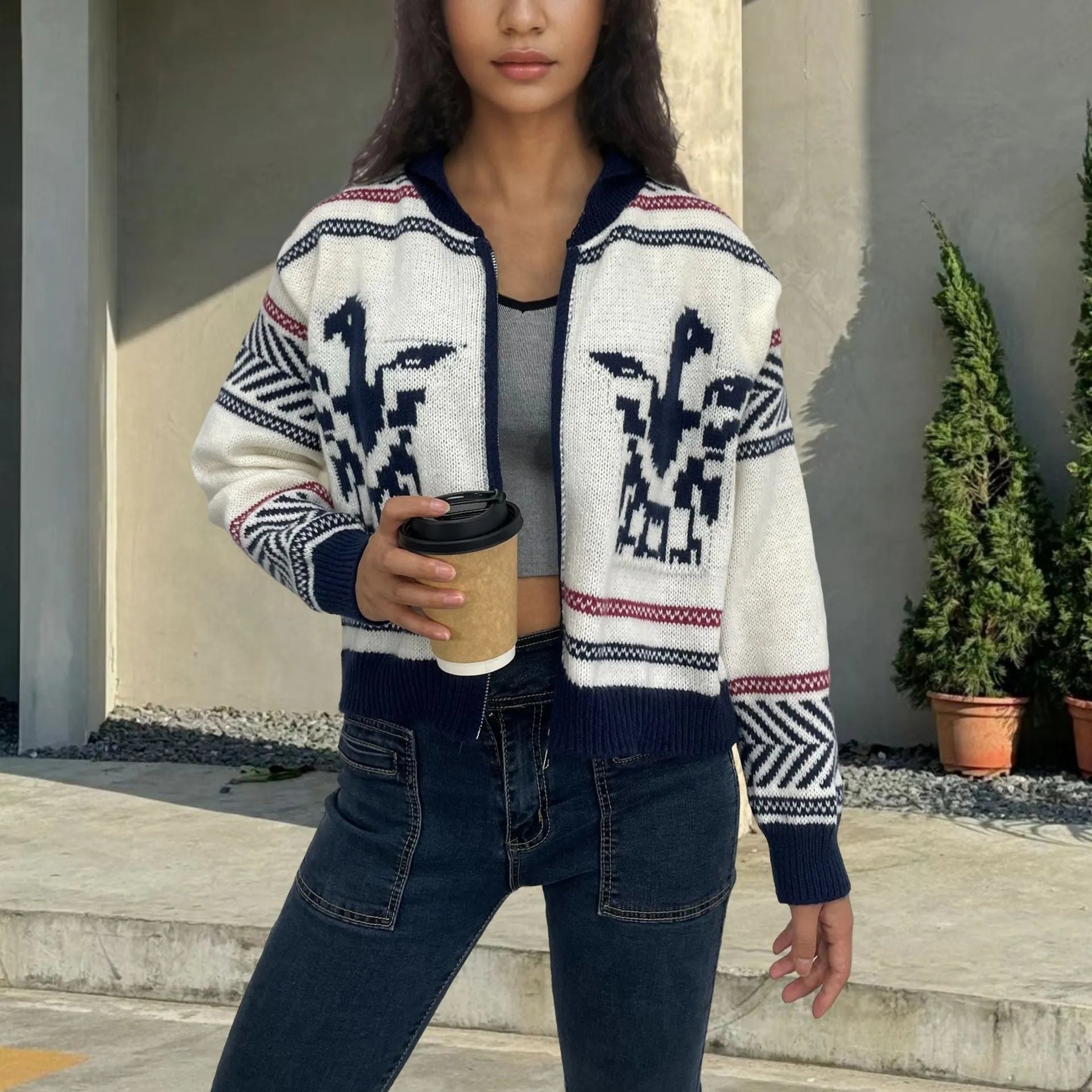 White women's zip-front cardigan with contrast striped jacquard pattern and lapel collar.