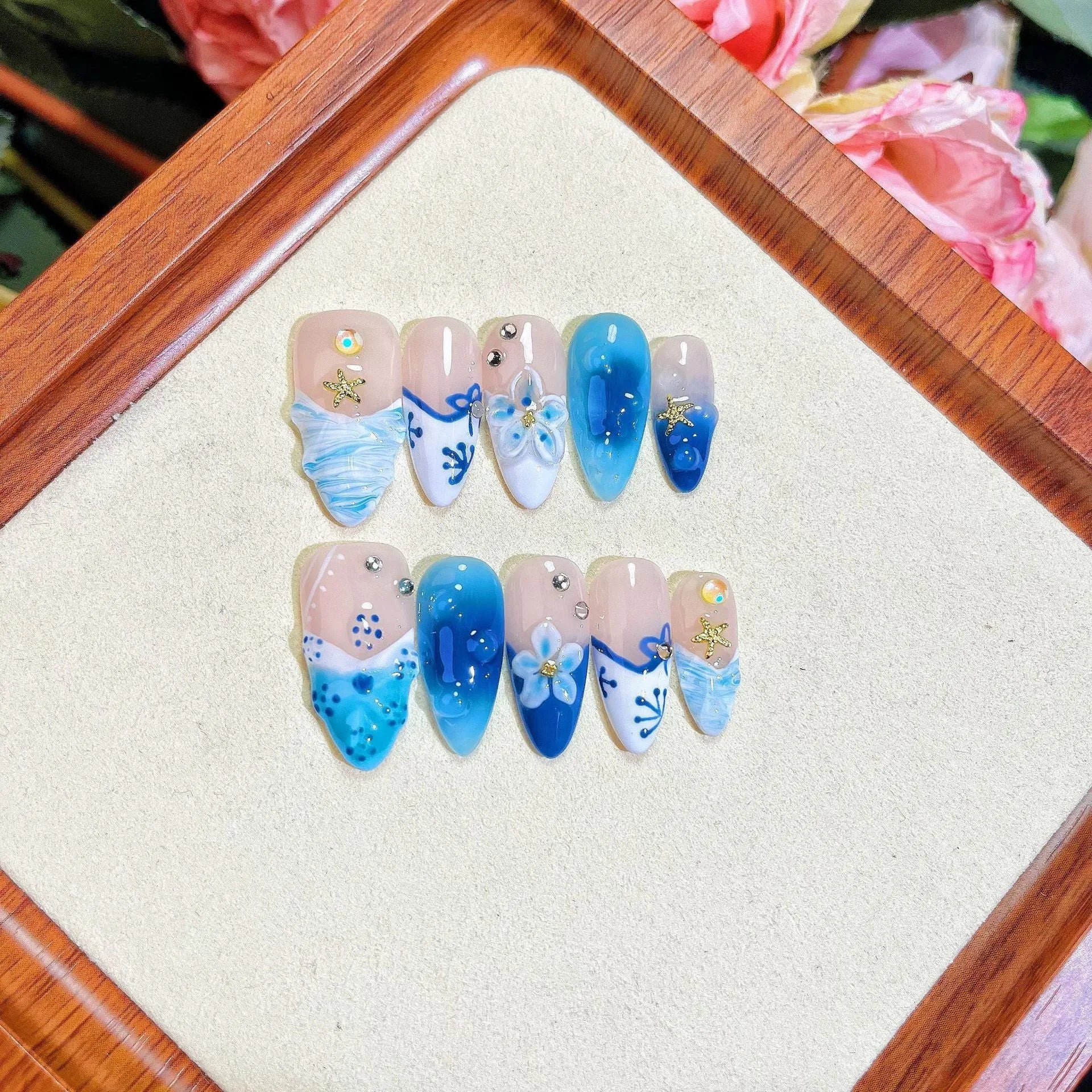 Blue hand-painted carved fake nails on transparent base with four size options