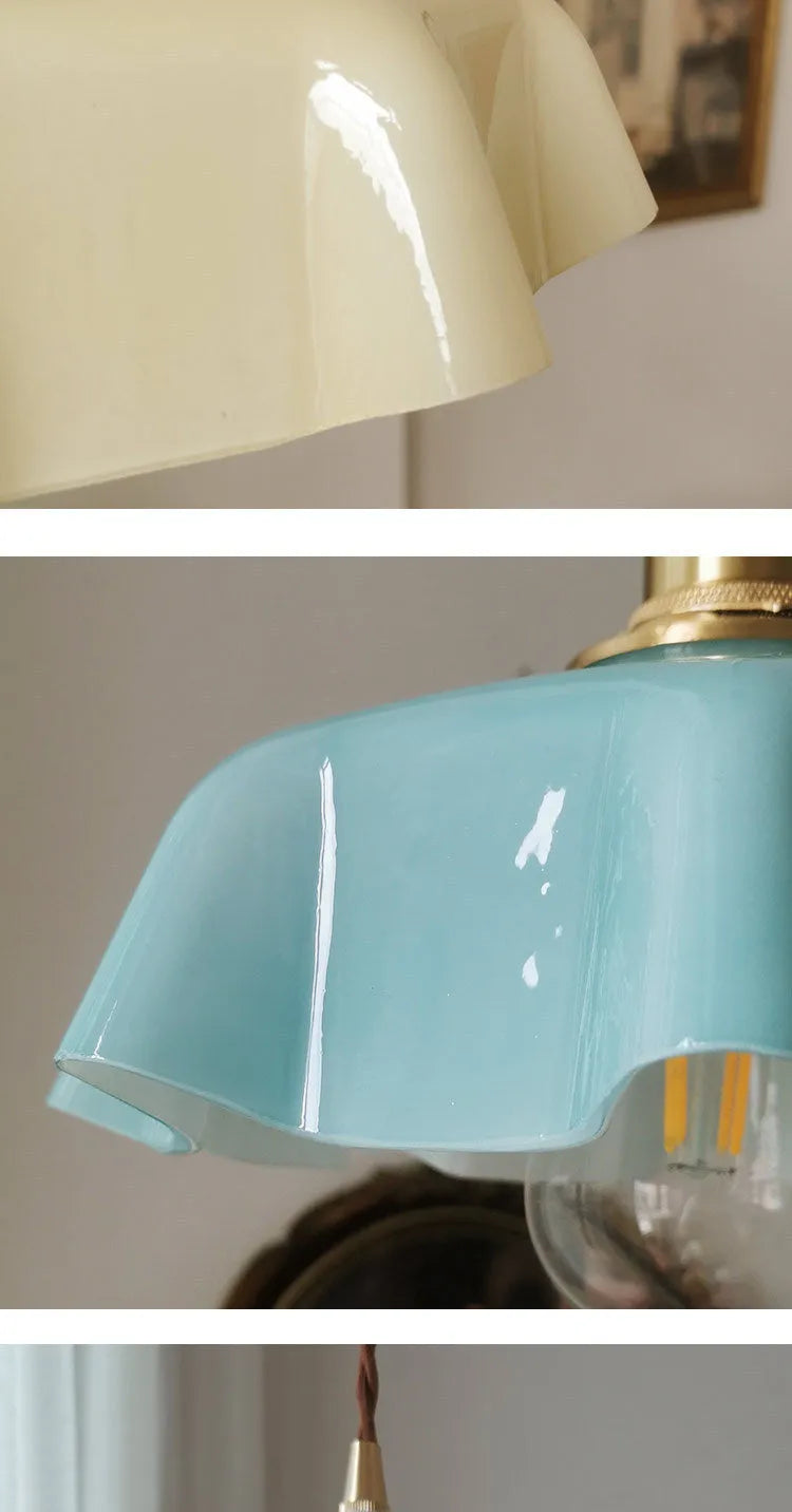 Medieval brass flower bud design glass chandelier hanging from a ceiling, shown in a light blue colour variant.