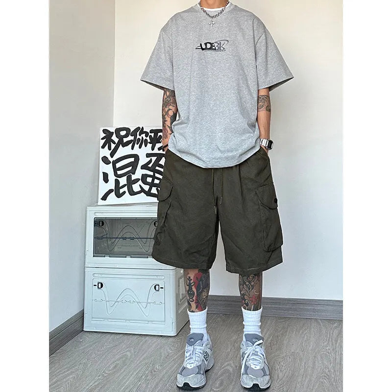 Man or woman wearing loose straight-cut black polyester casual sports shorts with a micro-elastic fabric.