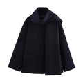 Women's long grey polyester overcoat with artificial fur collar and pockets, shown in a street fashion style.