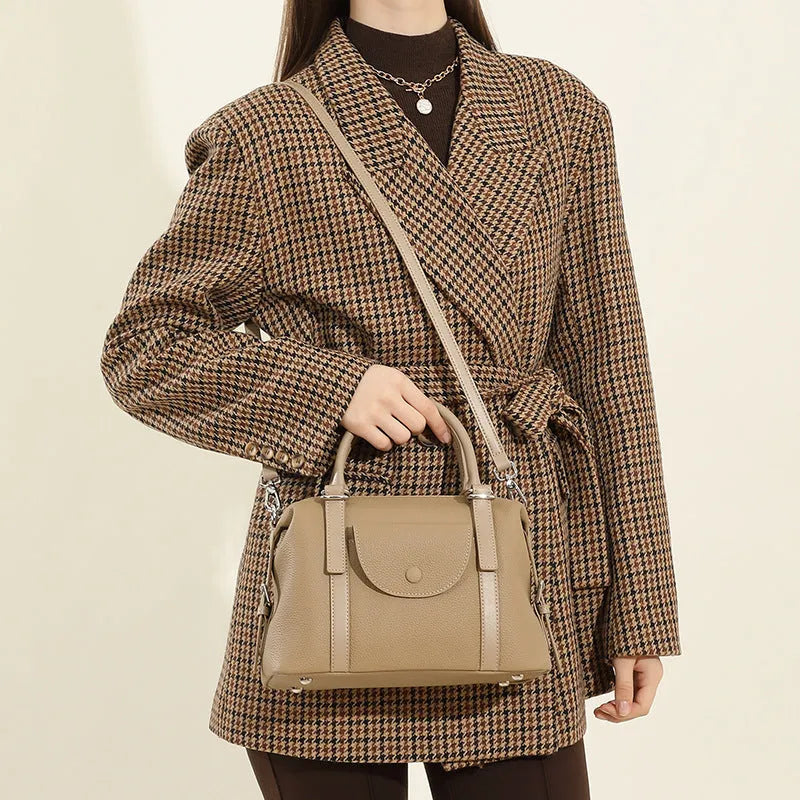 Genuine leather street trend ladies handbag with lock detail in black, brown, or elephant grey