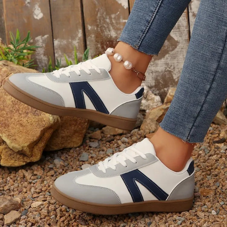 Blue women's low-top hiking training shoes with a lace-up front and rubber sole.