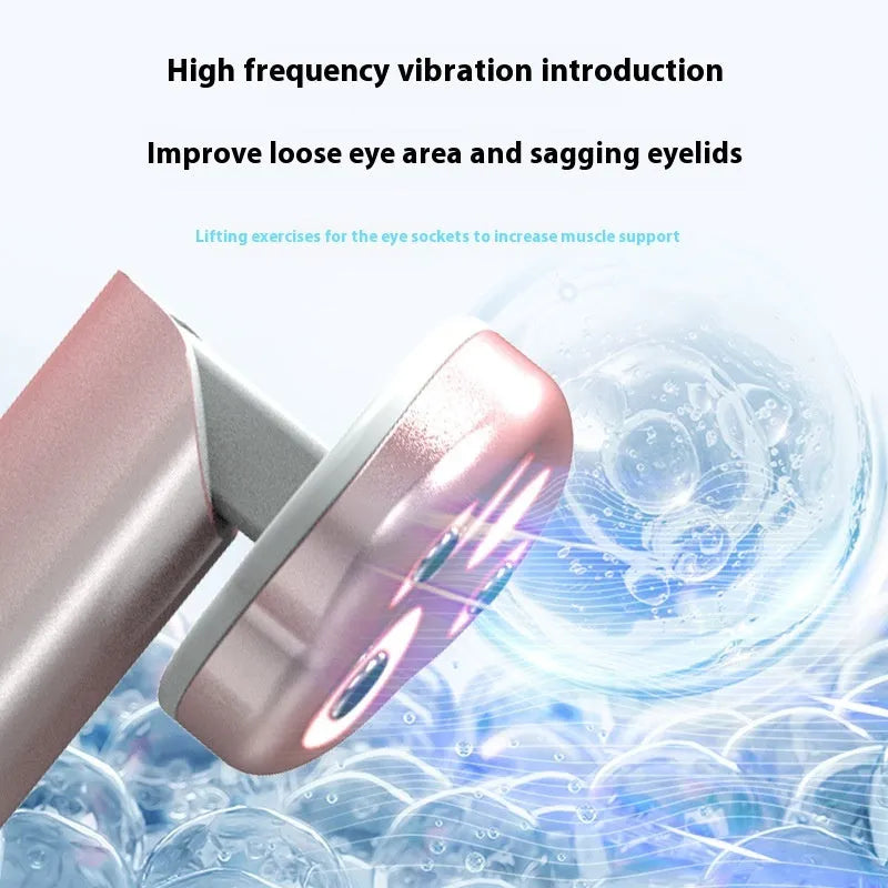 Gradient pink cats paw shaped micro-current eye massager on a white background