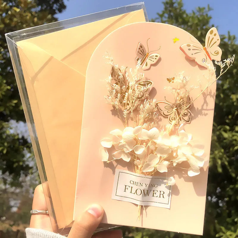 Handmade 3D butterfly-shaped birthday card with artificial flowers and hot foil stamping details.