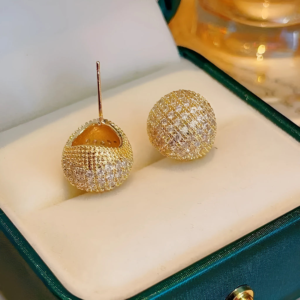 Drop-shaped geometric sphere earrings with full diamond design and little golden beans details in gold colour