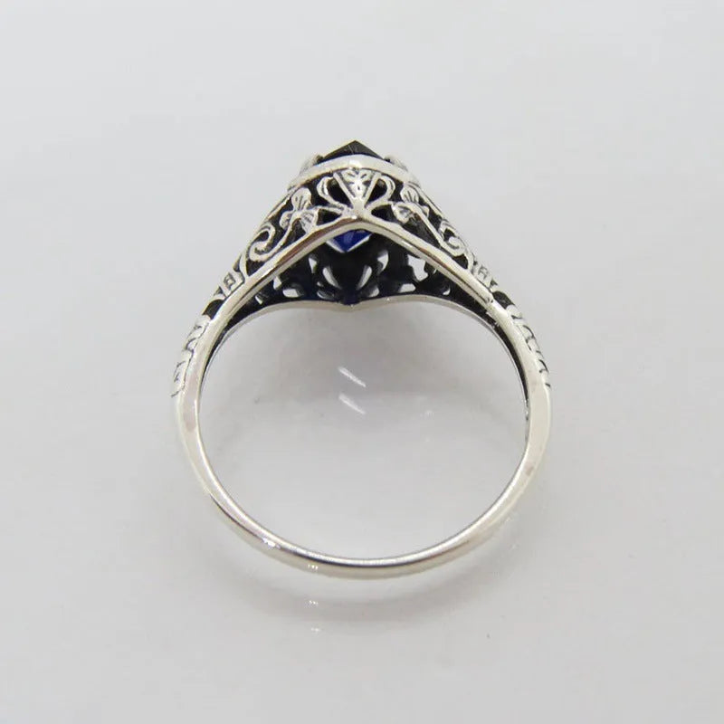 Silver geometric hollow women's ring on a hand, showing its alloy and electroplated construction.