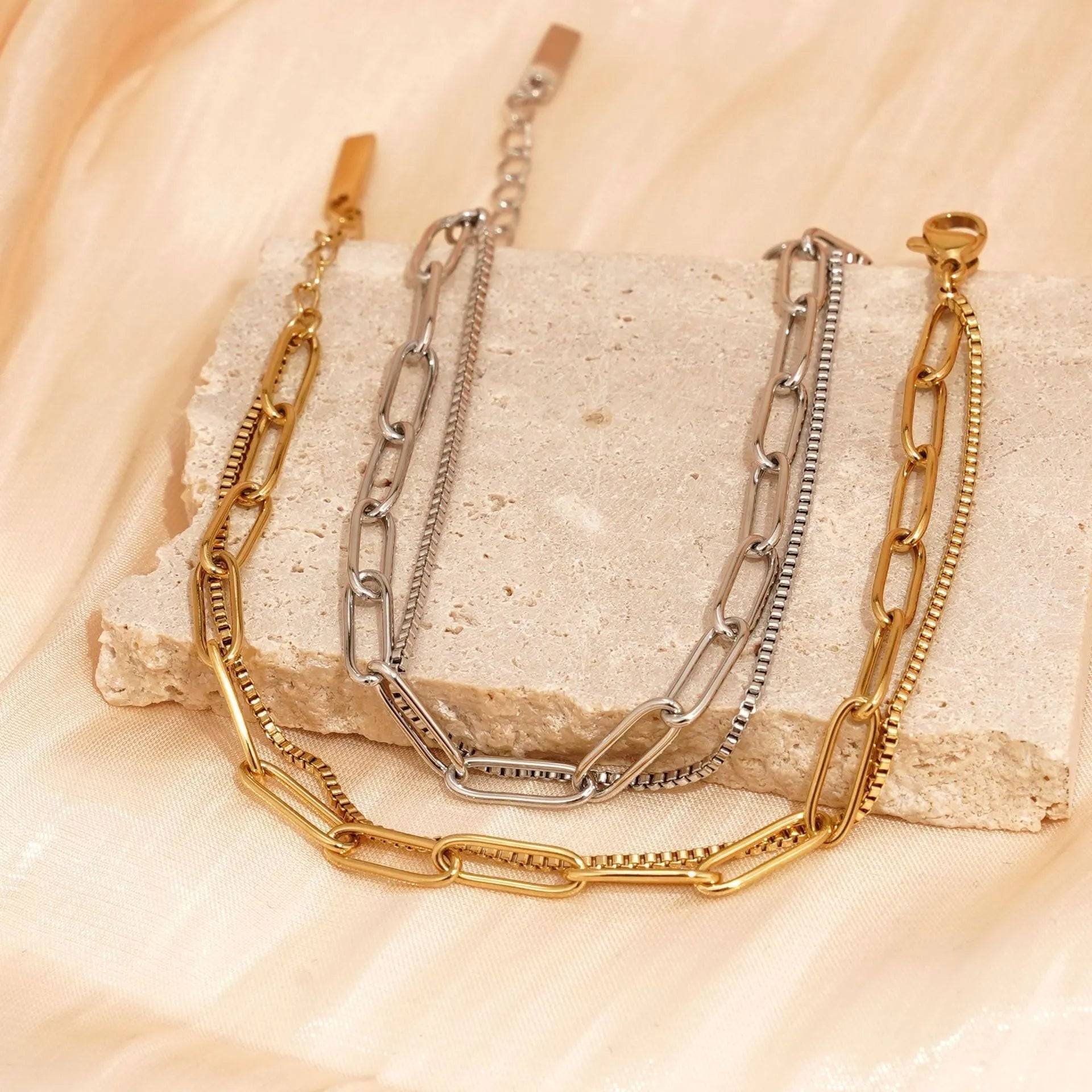 Women's double layer twin titanium steel bracelet in a geometric cold style, shown in gold and silver colours.