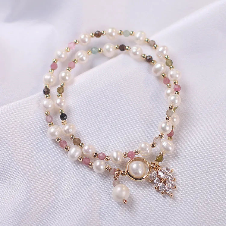 Red double-layer crystal bracelet with Lucky Cat charm and floral beads on wrist