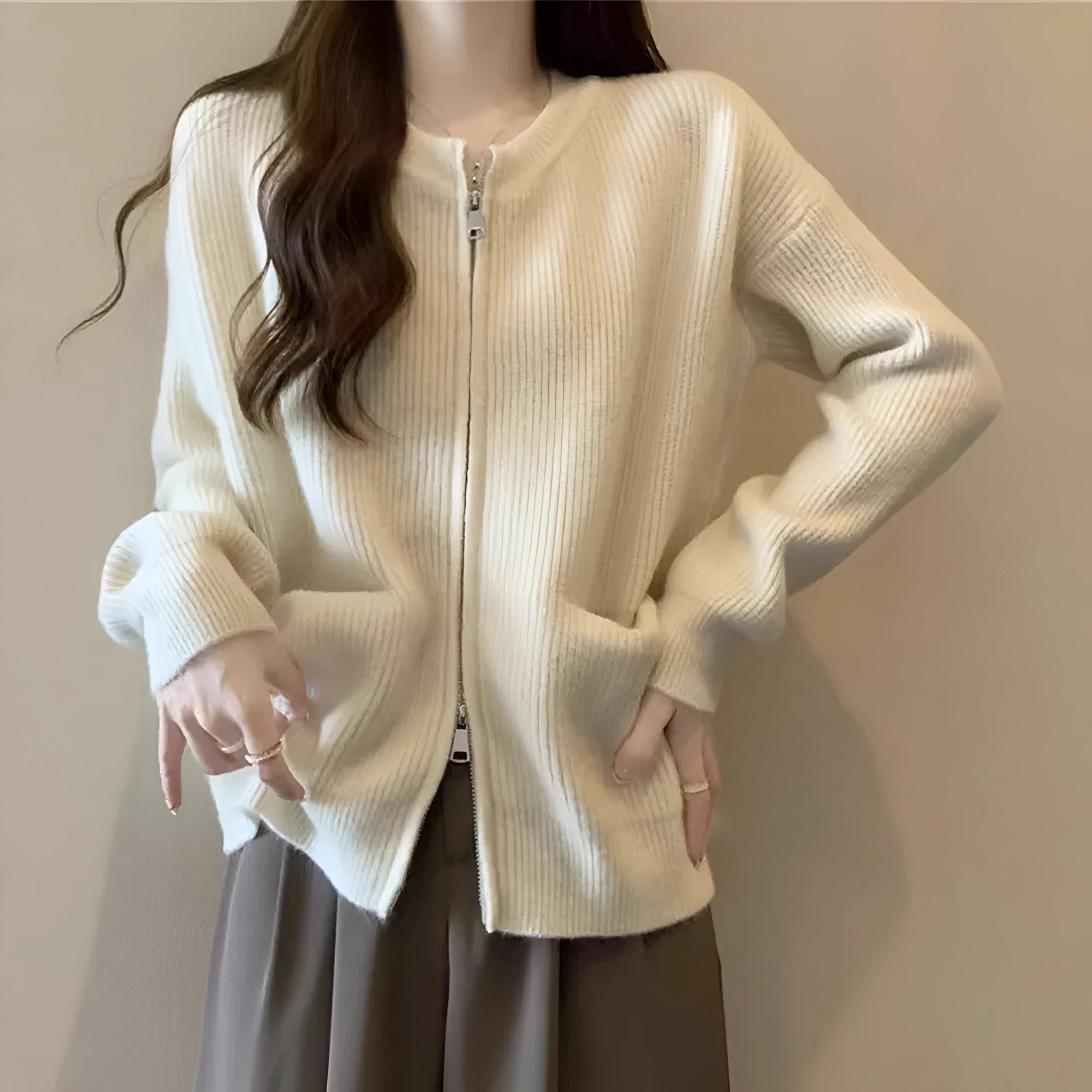 Beige women's soft viscose sweater coat cardigan with long sleeves on a hanger.