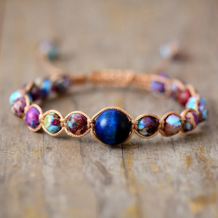 Hand woven adjustable friendship bracelet with a grey Emperor Stone centrepiece on a neutral background