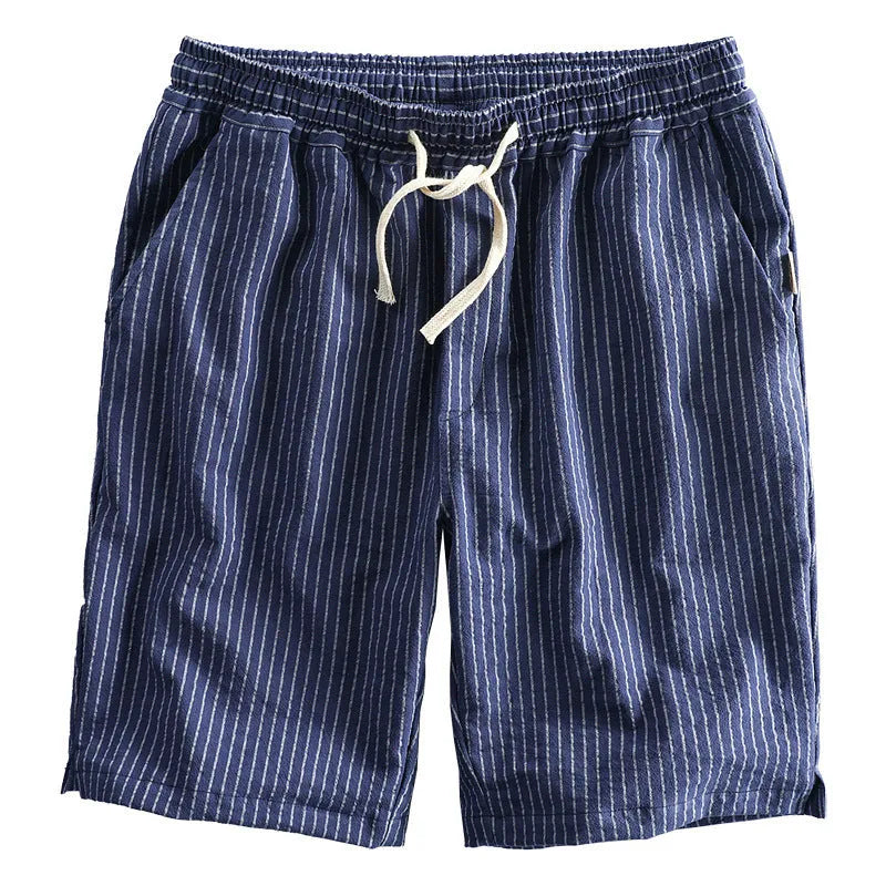 Man wearing striped cotton shorts with an elastic waistband in a light grey colour.