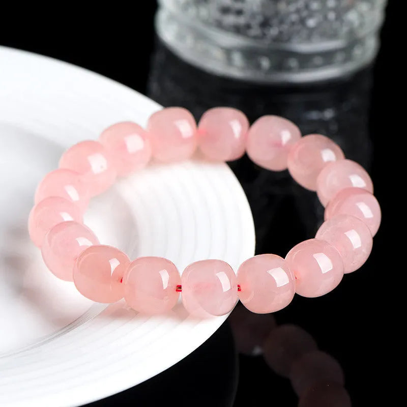 Pink natural crystal barrel bead bracelet with geometric shapes measuring 8-10mm